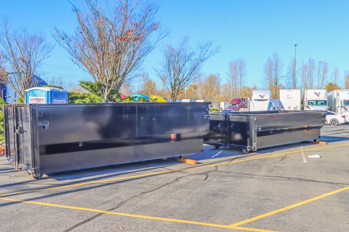 Professional dumpster rental service with roll-off container on residential driveway in Lemon Grove